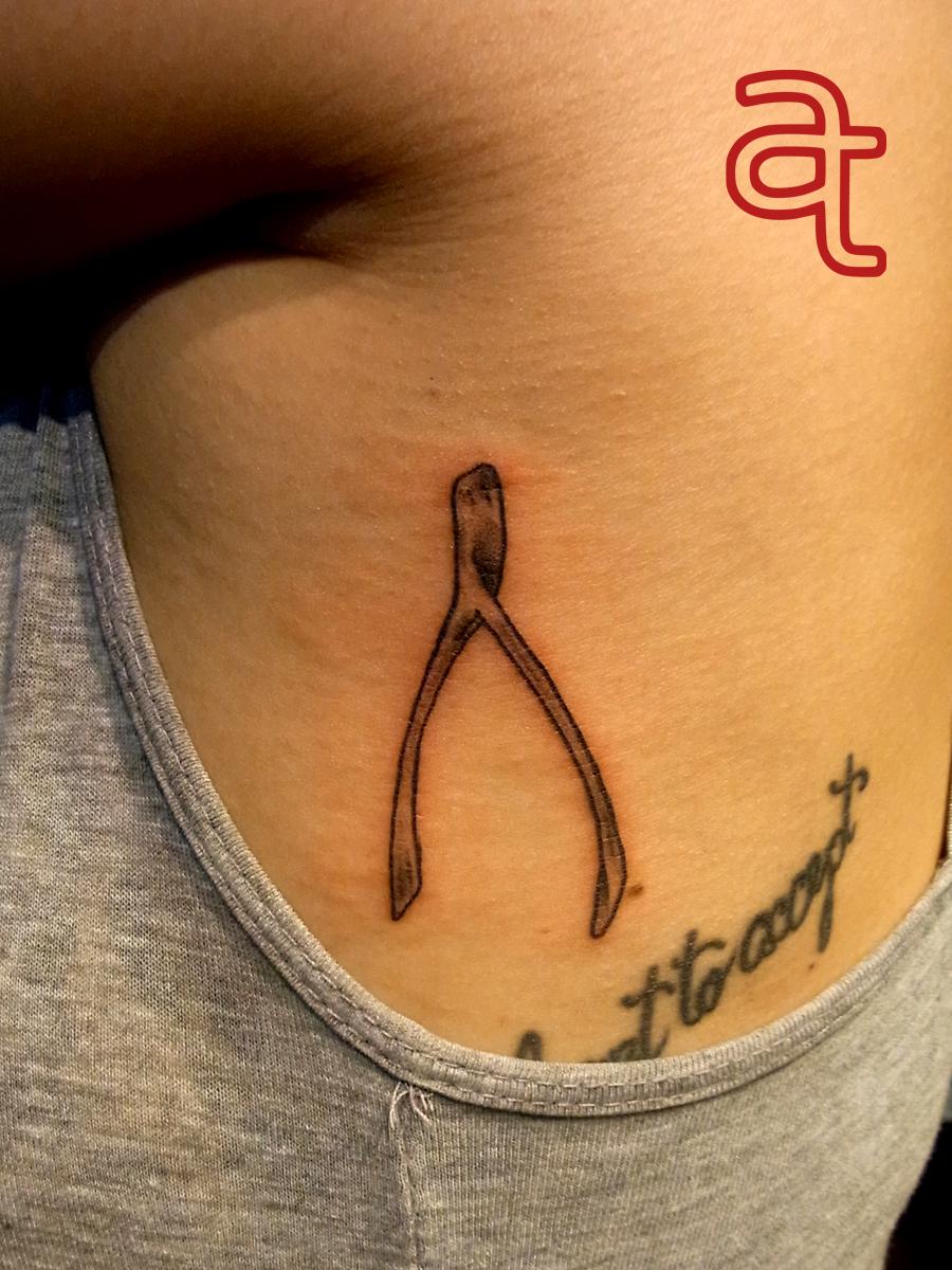 Wishbone tattoo by Dr.Ink Atkatattoo