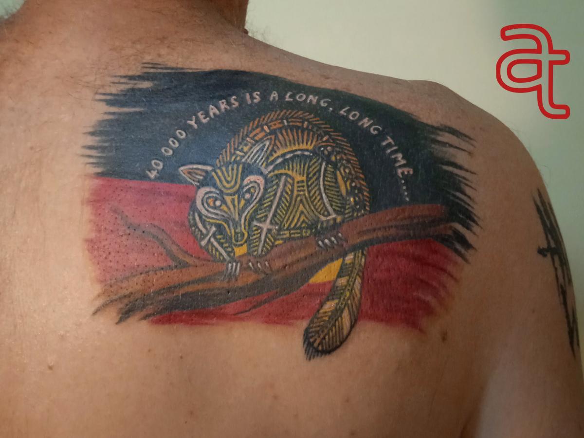 Aboriginal flag tattoo by Dr.Ink Atkatattoo
